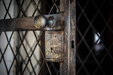 An old, rusty lock and latch in an abandoned building