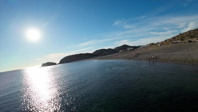 fast drone flight over the sea heading to the beach fast fpv with fast movements