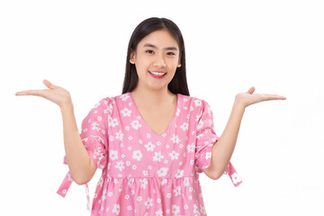 Pretty young confident Asian girl in a pink shirt smiling and showing hand to present something isolated on white background