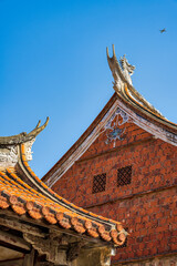 South Fujian historical red brick houses exterior with a plane flying over