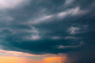 Naklejka na ściany i meble Dark clouds with heavy rain . Hurricane clouds in twilight