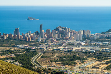 Naklejka na ściany i meble skyscrapers, apartment buildings and hotels with the sea in the background. Dense buildings of the city of Benidorm, seen from above. Blue sky, horizontal