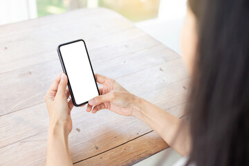 cell phone blank white screen mockup.hand holding texting using mobile on desk at office.background empty space for advertise.work people contact marketing business,technology