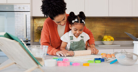 Mother, girl learning baking in kitchen and rolling flower dough on counter to cook cookies for...