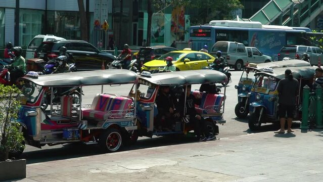 BANGKOK, THAILAND. 29.01.2023. Traditional Tuk Tuk in the street. Auto rickshaws are the fastest ways of getting around congested Bangkok streets. High quality FullHD footage