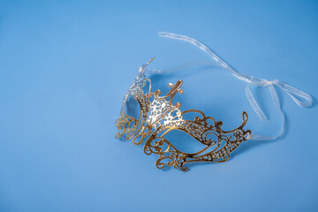 Festive face mask for masquerade or carnival celebration on colored background