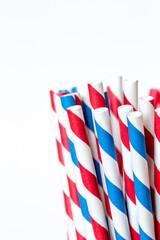 Multi-colored paper straws for drinks close-up on a white background.