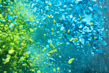 Fototapeta na wymiar A burst of colorful blue-green particles. Abstract background with slpash