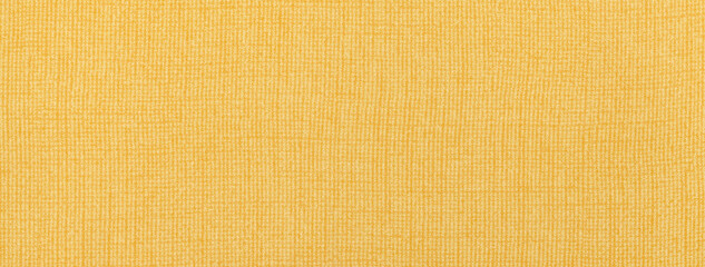 Texture of light yellow color background from textile material with wicker pattern, macro. Vintage golden fabric cloth