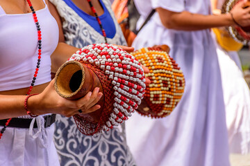 Woman playing a type of rattle called xereque of African origin used in the streets of Brazil...