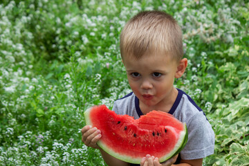 A child eats a watermelon. Selective focus.