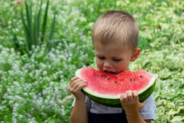 A child eats a watermelon. Selective focus.