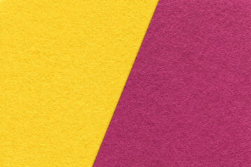 Texture of craft purple and yellow paper background, half two colors, macro. Vintage kraft wine and golden cardboard.