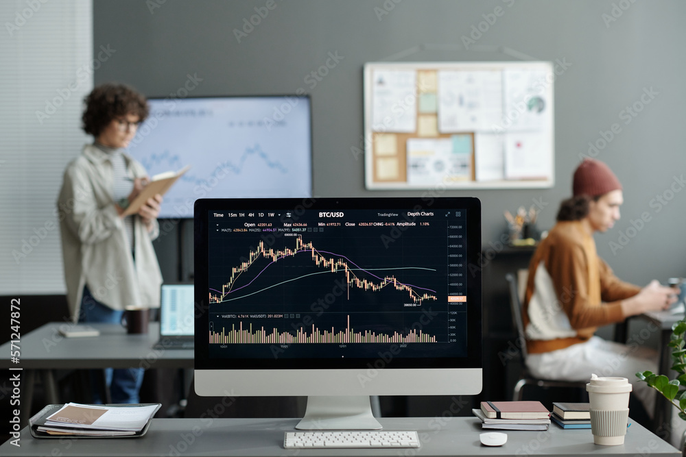 Fototapete computer monitor with graphic financial data on screen standing on workplace of modern crypto analys