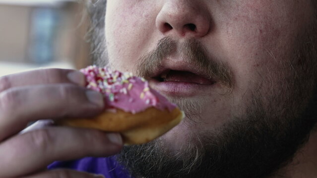 Chubby Man Eating Unhealthy Food. Person Taking A Bite Of Donut Snack