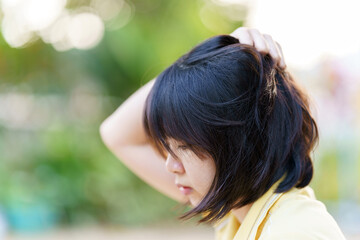 Women have itchy head due to dandruff or scalp dermatitis. Health care concept.