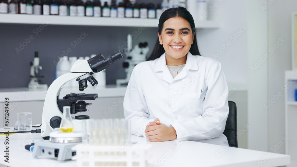 Poster Portrait of a female scientist using a microscope in a research lab. Young biologist or biotechnology researcher working and analyzing microscopic samples with the latest laboratory tech equipment