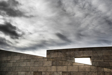 Abstract White granite building under cloudy sky