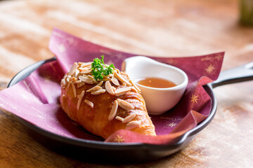 Delicious almond croissants with honey dipping.