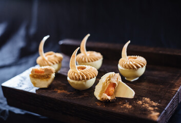Fashionable mousse cake in white chocolate. French dessert. Mini carrot cake.