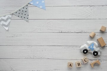 Baby boy background with blue flag banner, toys, space for text or product.