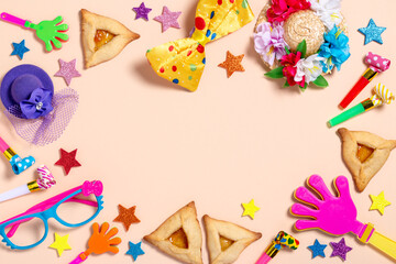 Purim carnival background with traditional cookies, costume accessories and decor on bright light background