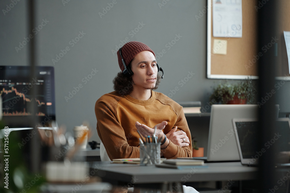 Aufkleber Young confident businessman with headset communicating with online clients and offering them help with solving technical problems