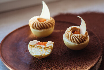 Fashionable mousse cake in white chocolate. French dessert. Mini carrot cake.