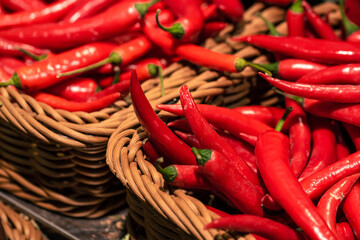Chili peppers in a basket in a supermarket, close-up.