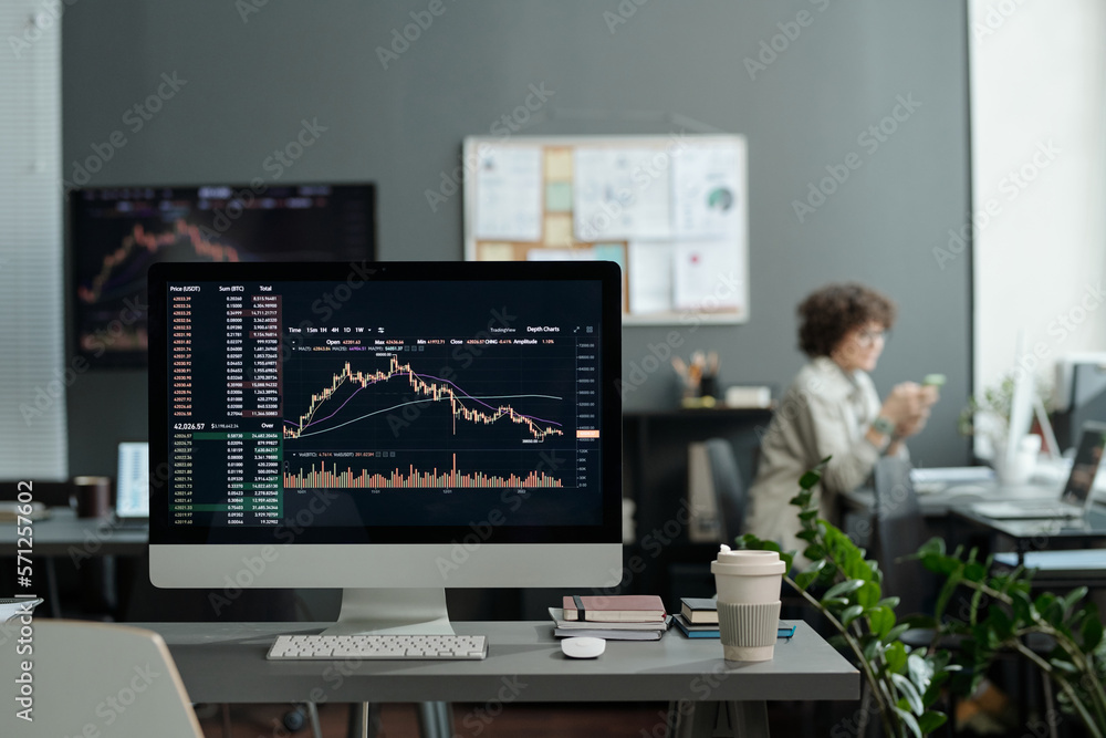 Aufkleber Workplace of broker or trader with graphic data illustrating development of situation on stock market on screen of desktop computer
