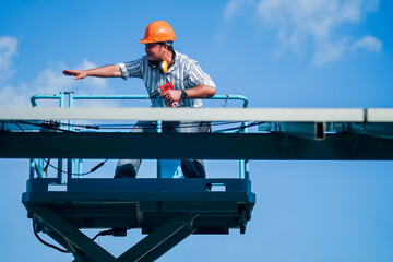 Technology solar cell, Engineer service check installation solar cell on the roof of factory. technician checks the maintenance of the solar panels