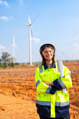 Wind turbine service engineer standing on ground planning for maintenance generator smile portrait