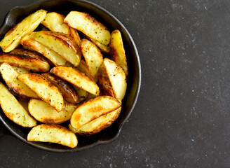 Potato wedges in frying pan