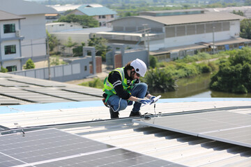 Maintenance engineer, Solar energy systems engineer perform analysis solar panels, Engineer service check installation solar cell on the roof of factory. 
