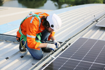 Maintenance engineer, Solar energy systems engineer perform analysis solar panels, Engineer service check installation solar cell on the roof of factory. 