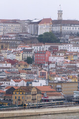Fototapeta na wymiar Portuguese city with white buildings and red-tiled roofs on a hill