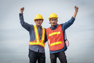 Asian engineers are happy to work together on the project.