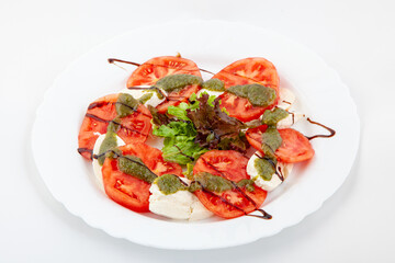 Caprese salad with mozarella cheese, tomatoes and basil