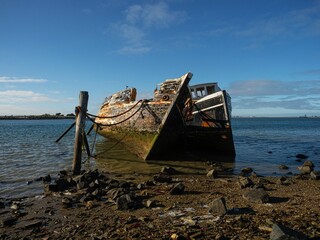 Remains ruins of an old historical capsized tilted fishing boat ship wreck at Greenpoint Ship...