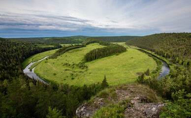 landscape with green hills and blue sky in Perm region Russia