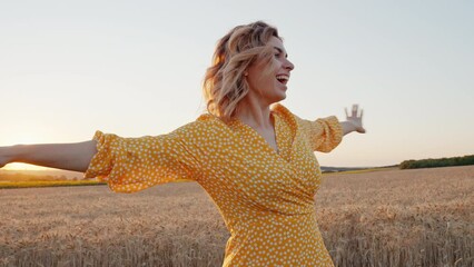 Joyful young woman spinning turn with happiness nature smiling in wheat field at orange sunset in summer looking at camera closeup. Rest from city life. Reloading people among nature. Relax. Lifestyle - Powered by Adobe