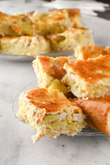 dish of chicken and potato pie on light background. portion of homemade pie on a white plate on a light table
