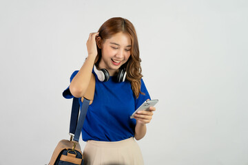 Attractive young asian college student with backpack on shoulder and holding smartphone doing hand...