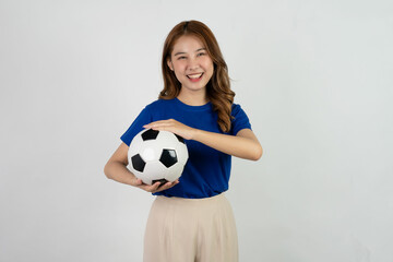 Happy Asian female soccer fan in blue shirt cheering for favorite team with soccer ball isolated on white background, pretty young pretty girl holding soccer ball, sports concept