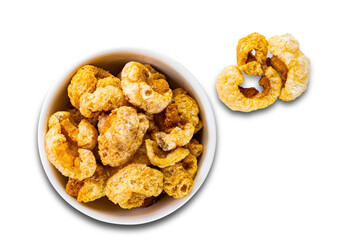 top view (flat ray) of crispy homemade delicious deep fried pork rinds in white ceramic bowl isolated on white background with clipping path.
