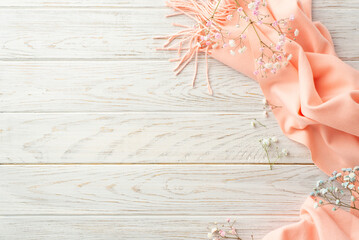 Hello spring concept. Top view photo of pink soft plaid and gypsophila flowers on grey wooden table background with copyspace