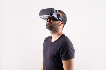 Young man using VR glasses headset, portrait on light background. Virtual reality, future technology, education video gaming.