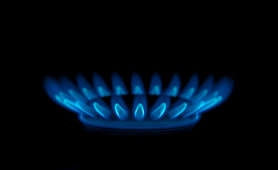 blue gas flame on the stove in the dark