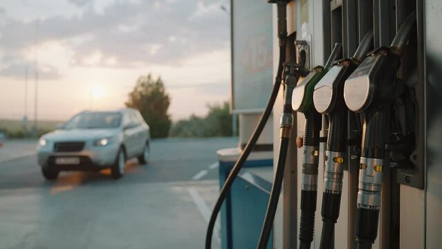 Car drives into gas station to refuel with diesel for travel in summer at dawn. Travel. Tourism