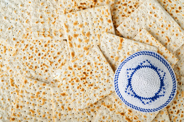 Passover celebration concept. Matzah, red kosher, white and yellow roses and walnut. Traditional...